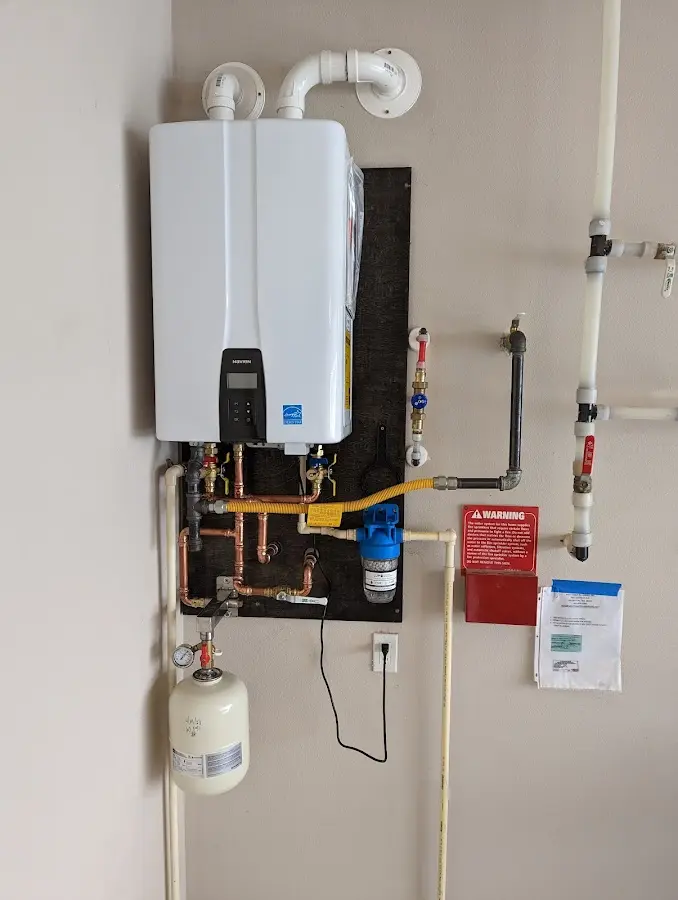 Professional plumber installing copper piping in a Woodmere home
