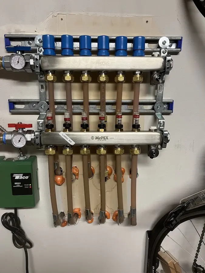 Plumber performing Water Heater Repair at a residential property in Woodmere